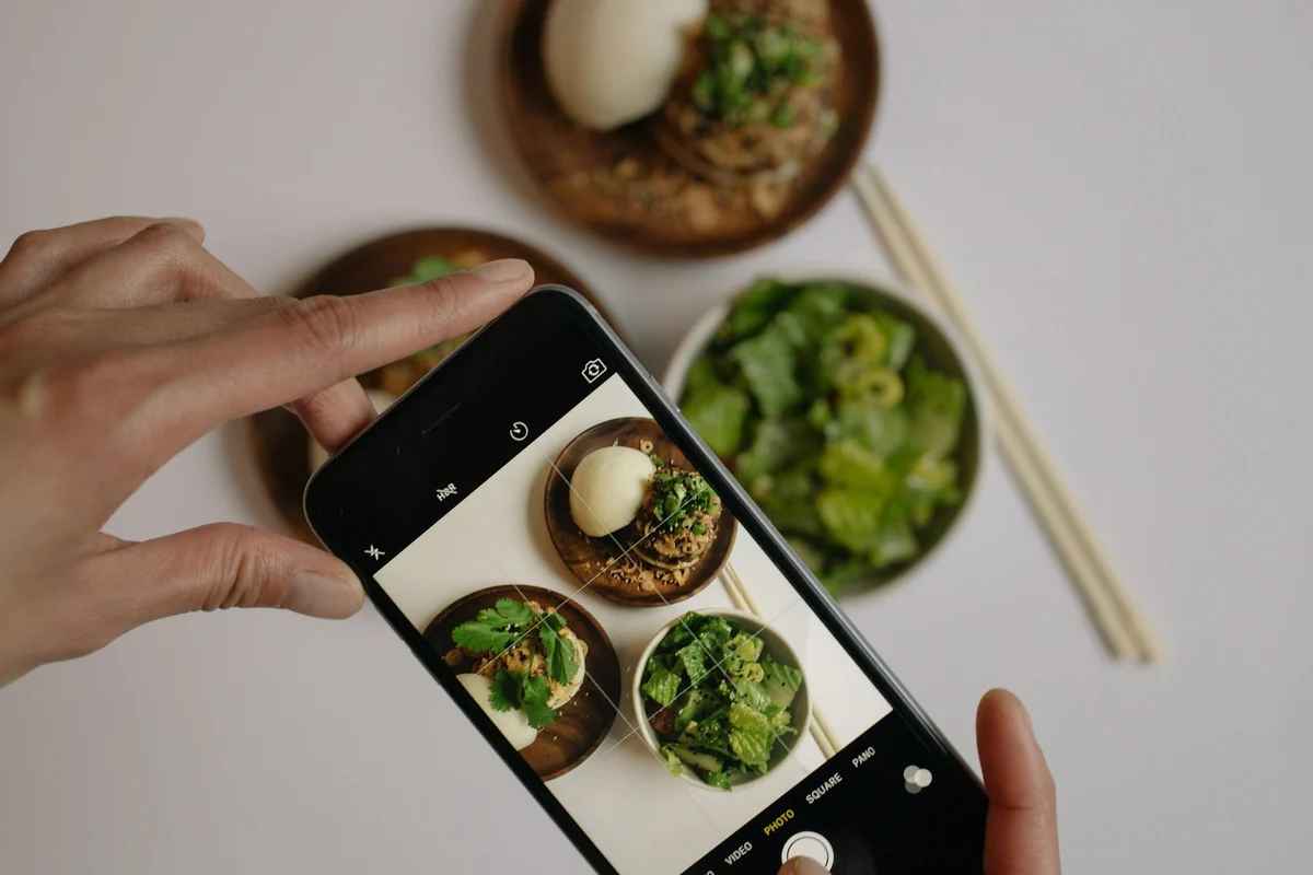 A phone shooting bowls of food from above, with the main dish filling most of the frame