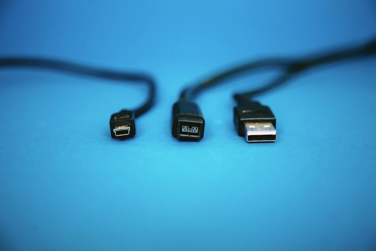 Three different USB plug types side by side on a blue background