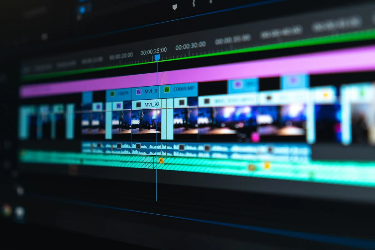 Close-up of a video editing timeline with blue and purple clips placed end to end